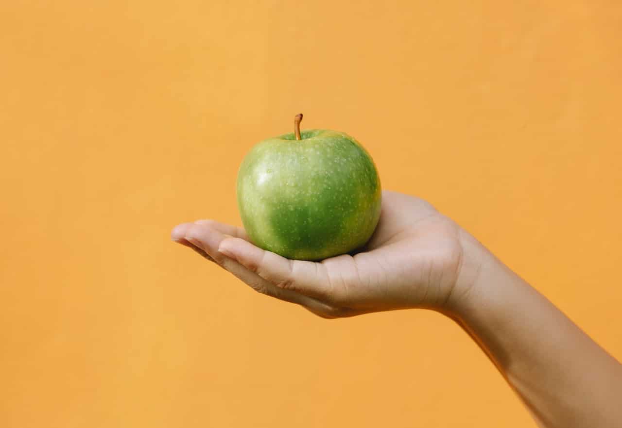 Hand holding an apple