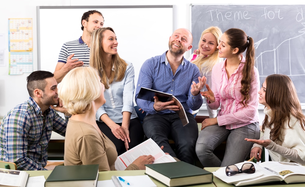 Teacher surrounded by students