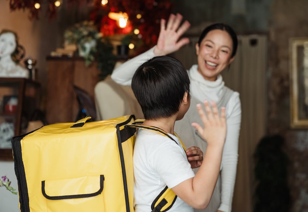 mother and son waving good-bye