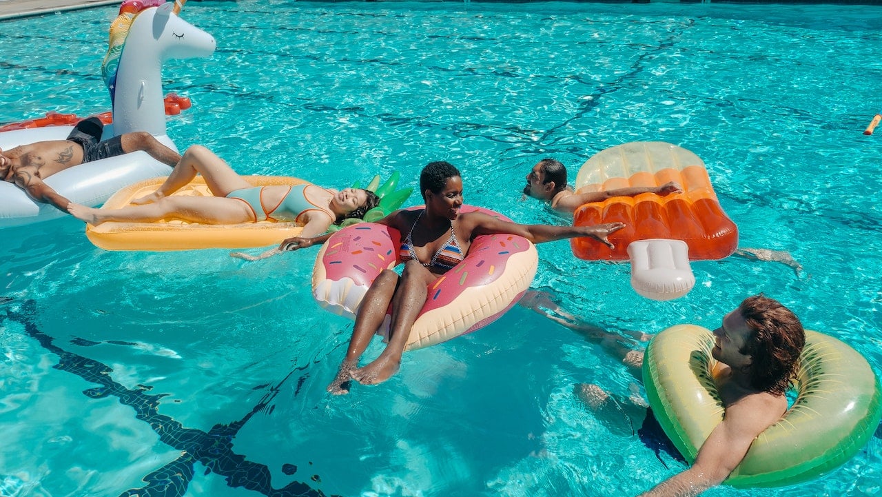 friends hanging out in the pool