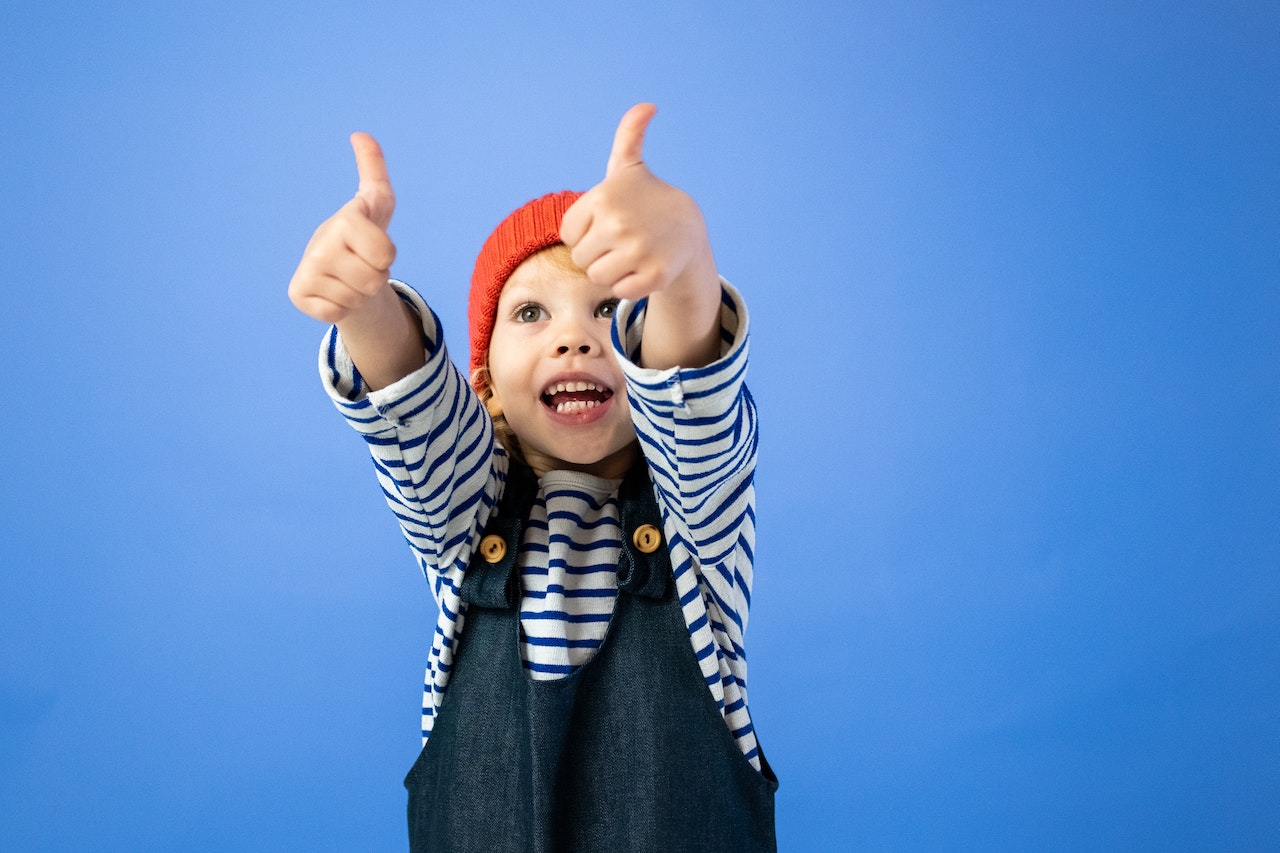 little boy with thumbs up