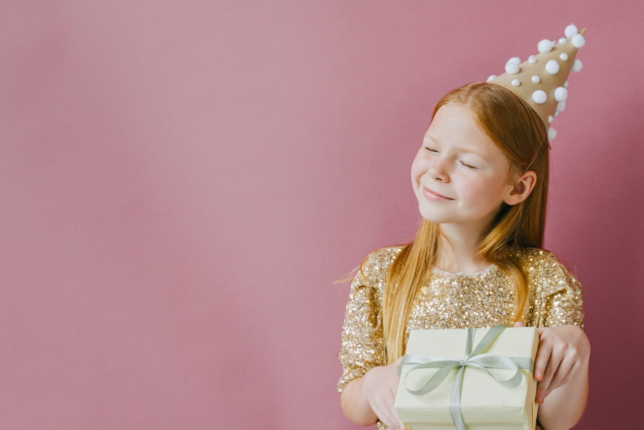 Happy kid opening her present