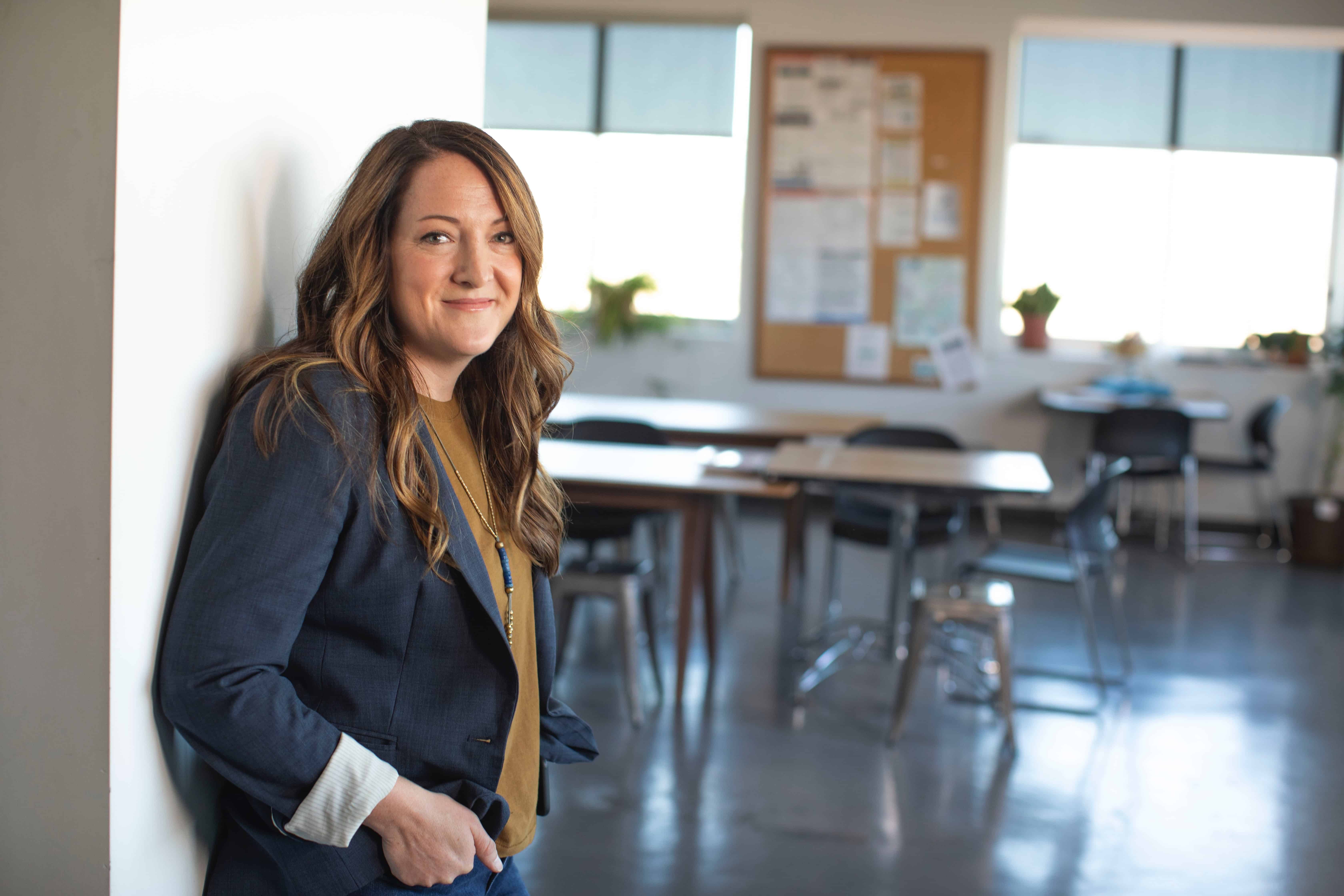 A teacher smiles in her classroom