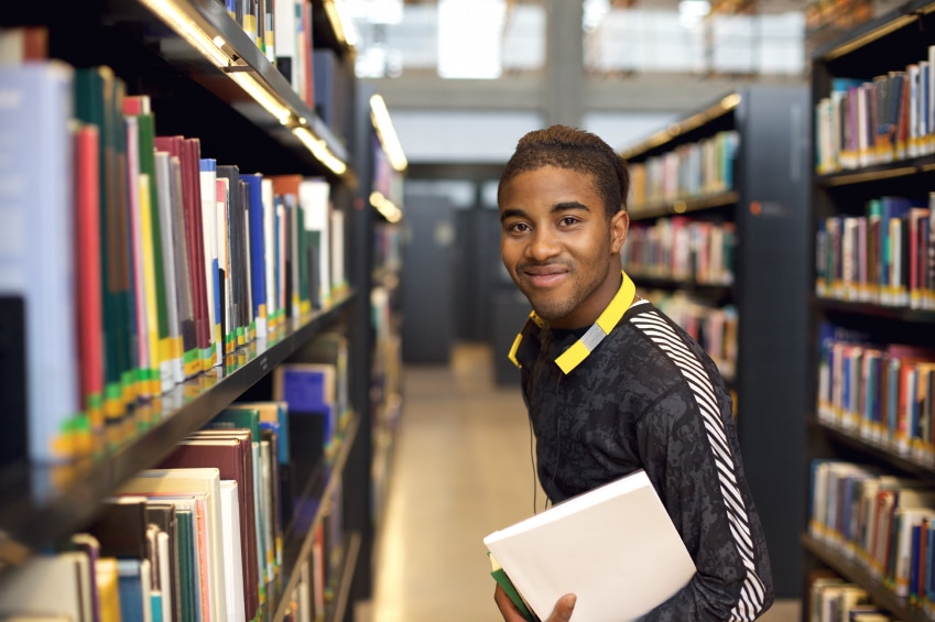 man in library looking for local books