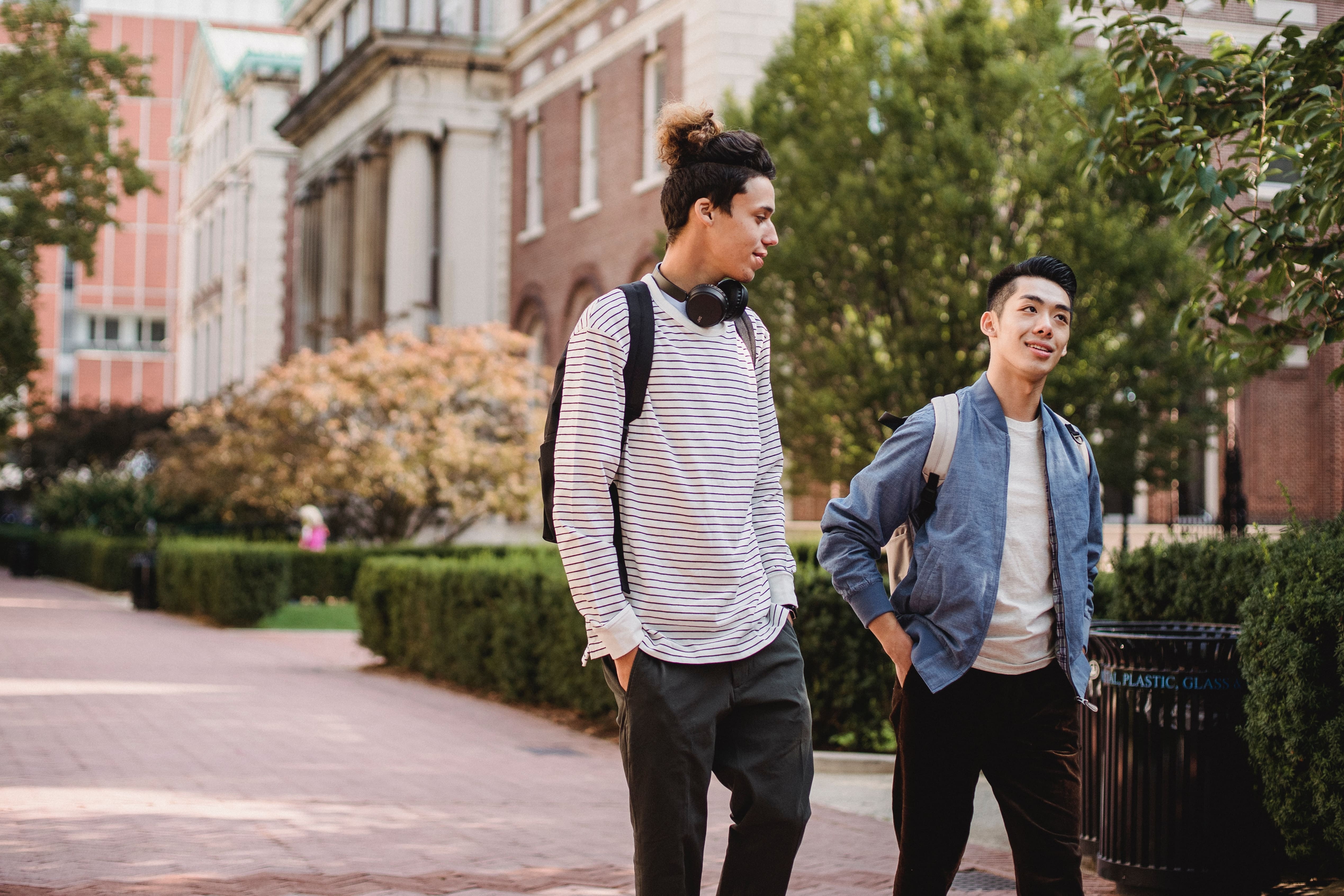 Two students walks and talks on campus