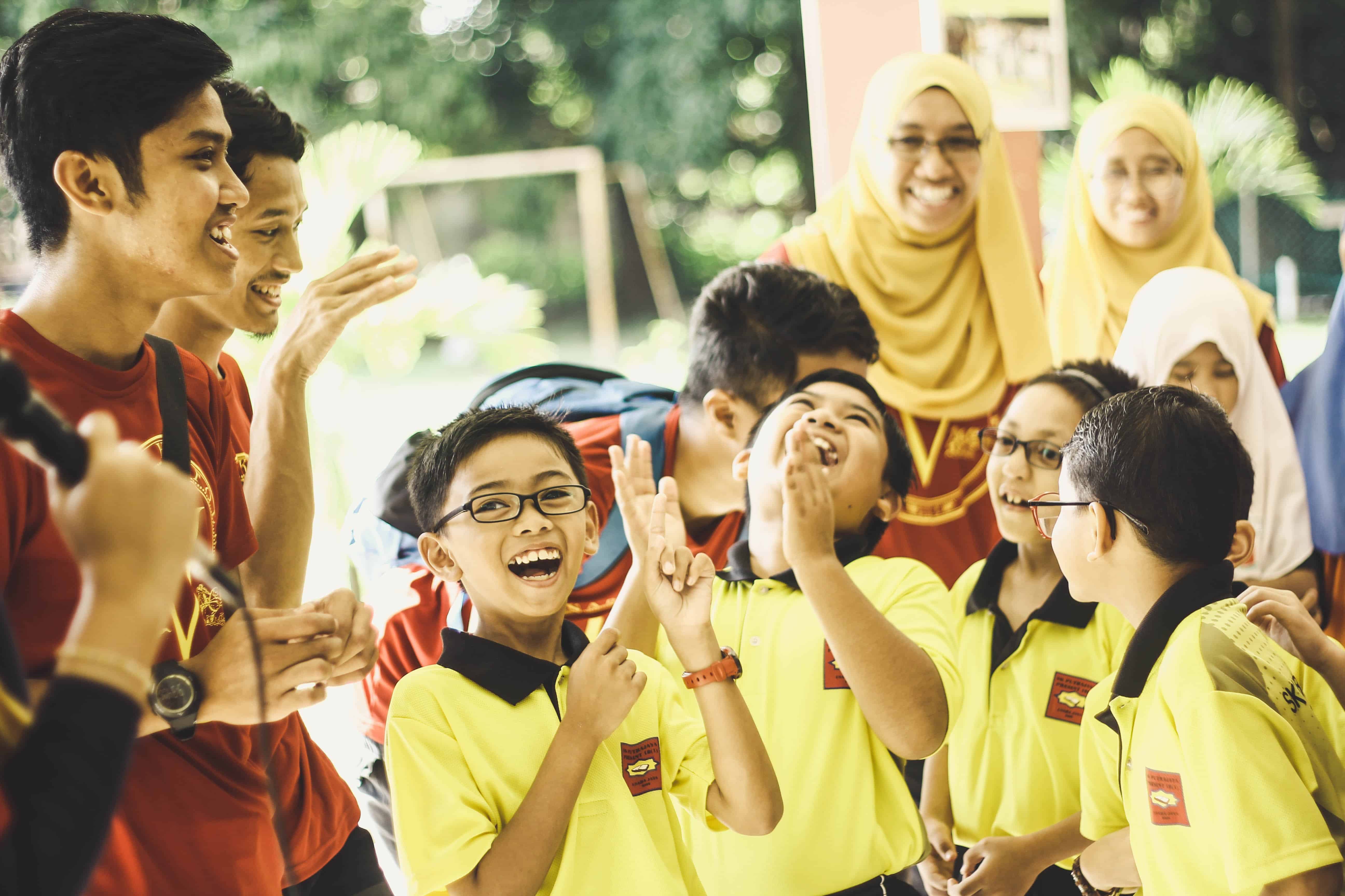 A group of students talks to their teacher